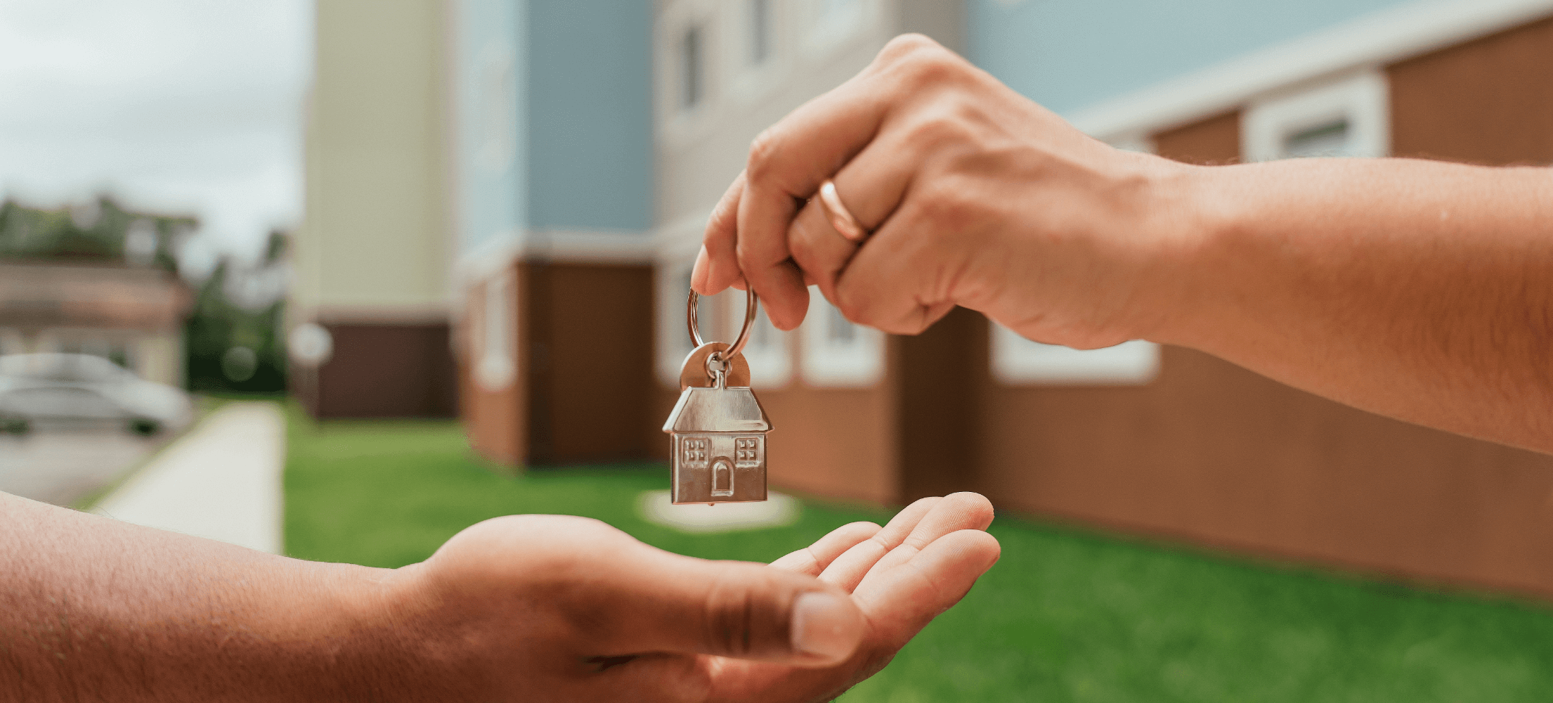 a hand passing a key to another hand