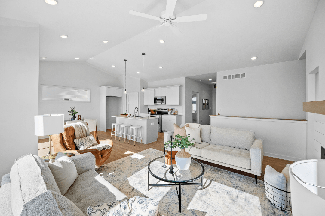Open-concept living room and kitchen with bright modern furnishings
