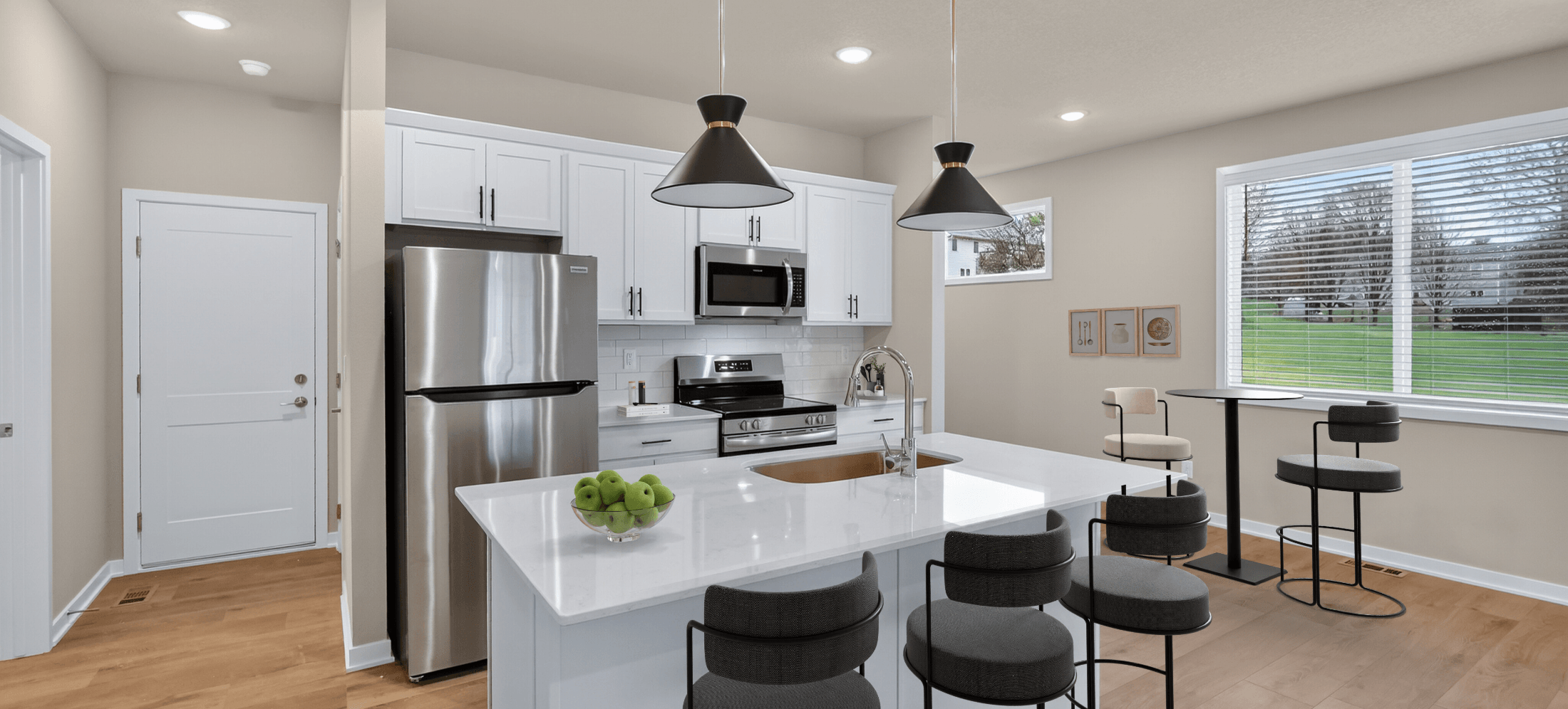 modern apartment kitchen dining area with island seasting and stainless appliances